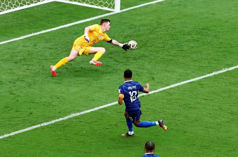 Kylian Mbappe scores France's first goal past England goalkeeper Dean Henderson.